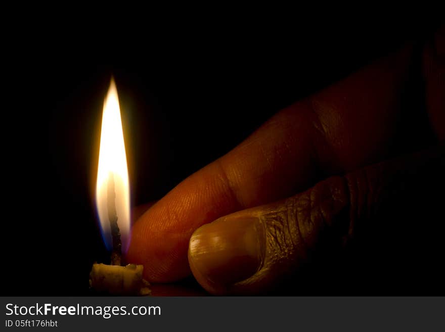 Flame of a burnt candle isolated on dark black background. Flame of a burnt candle isolated on dark black background.