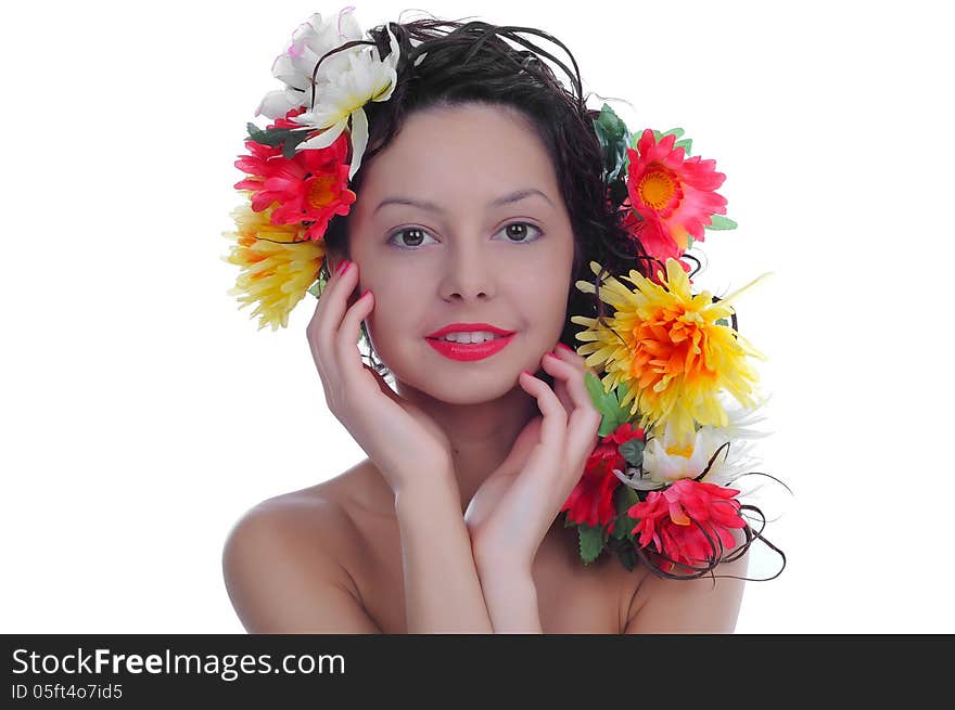 Portrait of young beautiful woman with flowers on the hair.