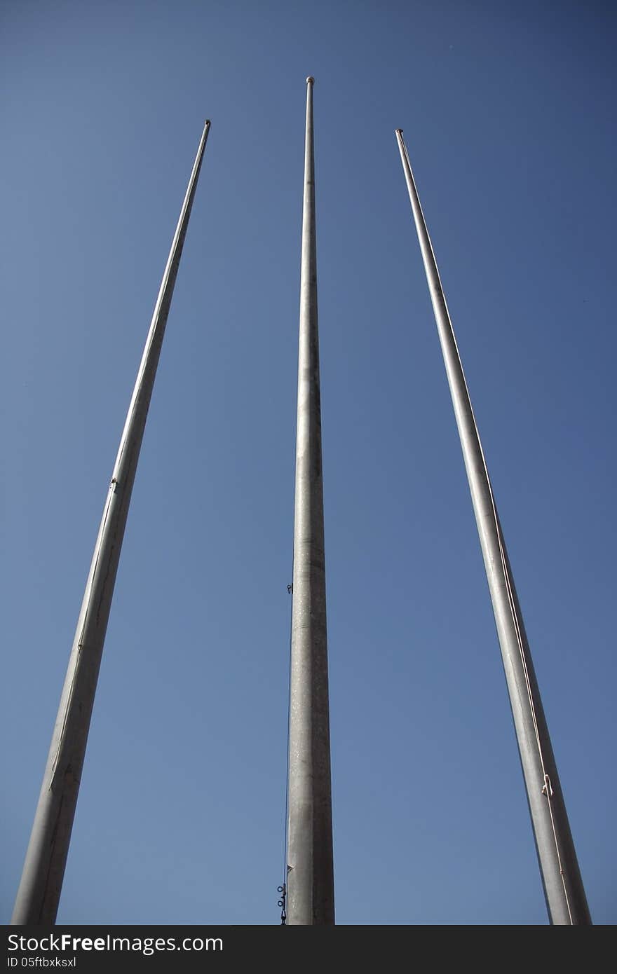 Tree flagpole vertical up to blue sky in Stadium