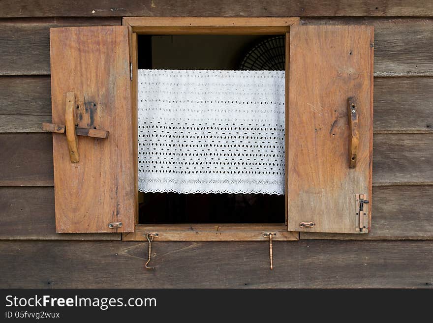 Old wooden window and the white blinds. Thailand traditional style