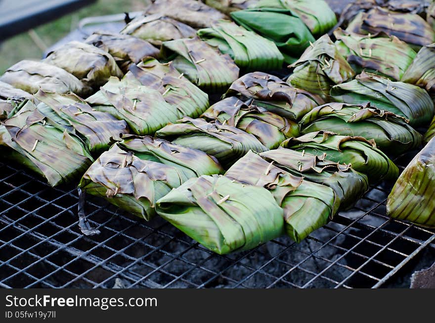 Fish with curry paste wrapped in banana leaves, grilled on charcoal. Fish with curry paste wrapped in banana leaves, grilled on charcoal.