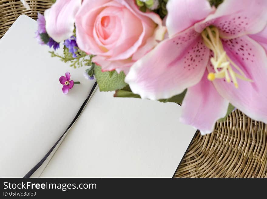 Pink flowers put with notebook blank page. Pink flowers put with notebook blank page