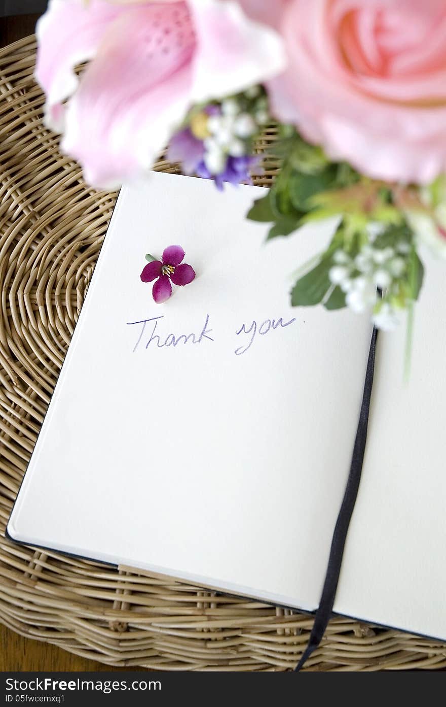 Thank you note on white page with pink blossom. Thank you note on white page with pink blossom