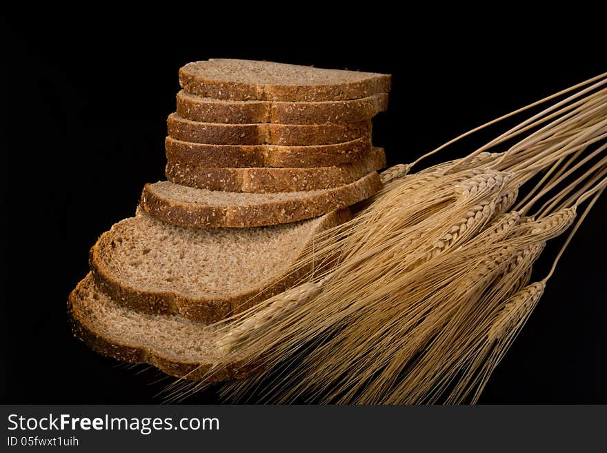 Wheat bread with stalks of wheat. Wheat bread with stalks of wheat.