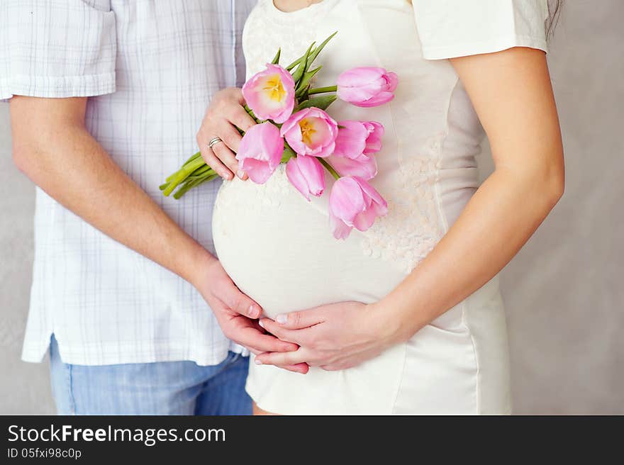 Pregnant woman belly with tulips. Pregnant woman belly with tulips