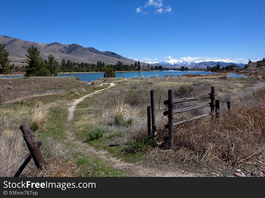 This image shows an angler's access site to the Flathead River with the snowy Mission Mountains of Montana in the background. This image shows an angler's access site to the Flathead River with the snowy Mission Mountains of Montana in the background.