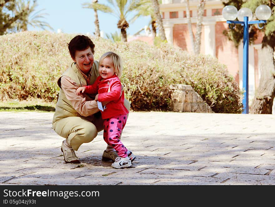 Grandmother and granddaughter playing together outdoors