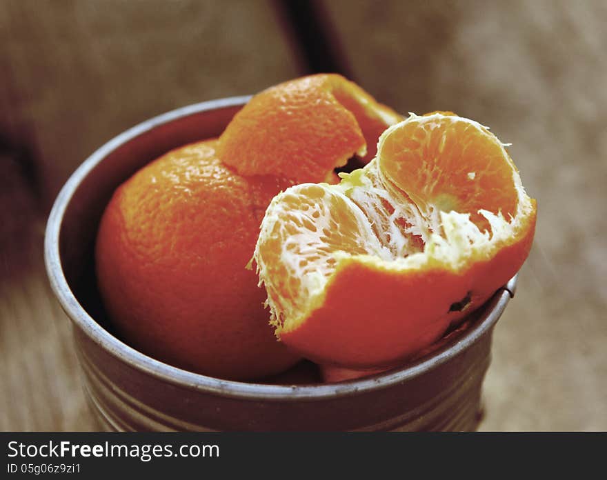 Tangerines on a natural wooden table. Photo in old image style.