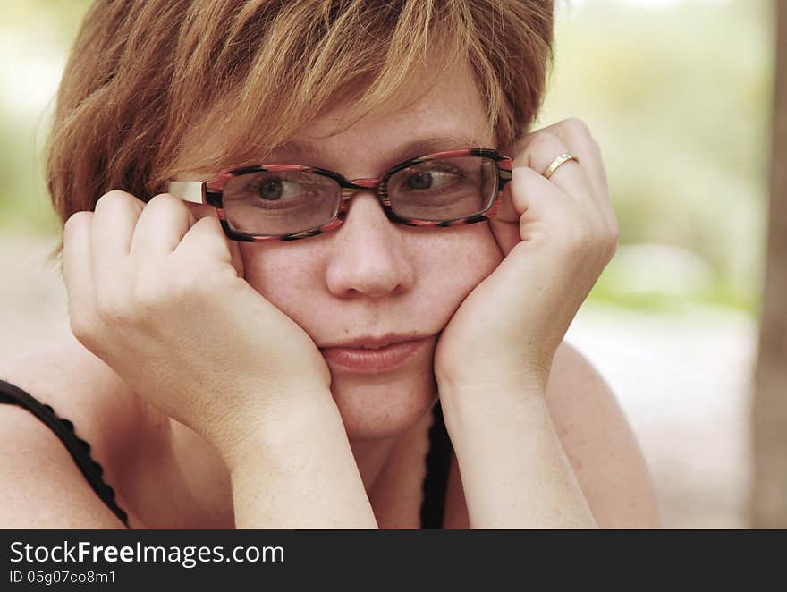 Close up portrait of sad redheaded woman