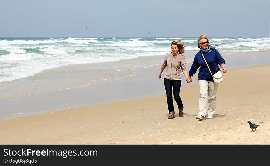 Mother and daughter on a winter beach