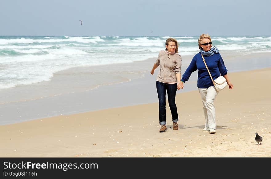 Mother and daughter on a winter beach