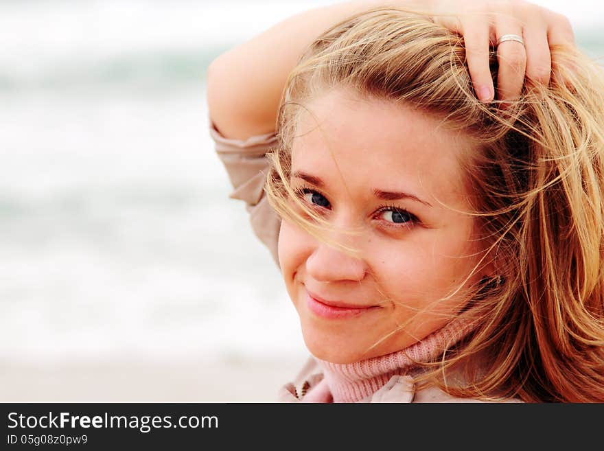 Young attractive woman near the sea on spring day