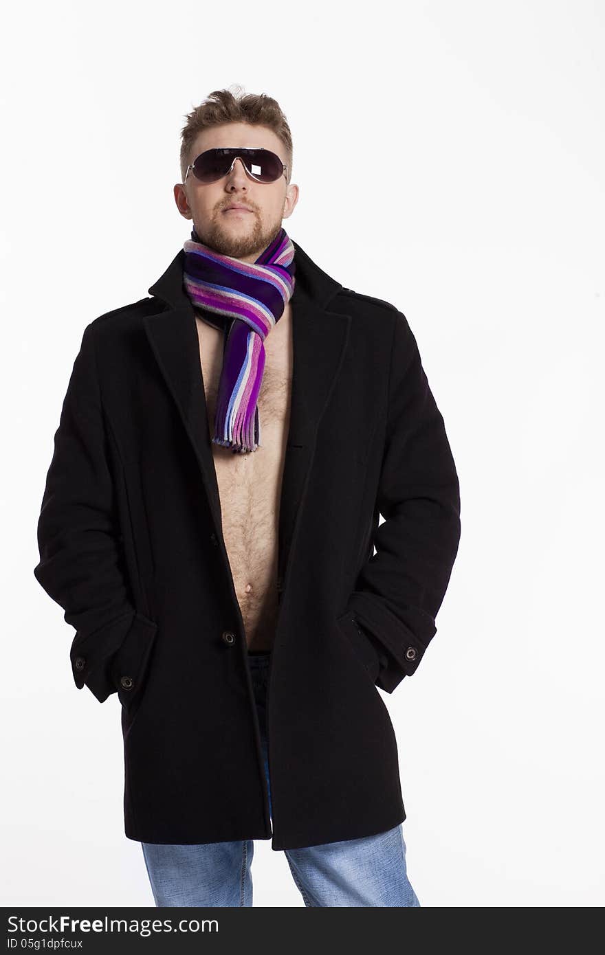 Portrait of handsome stylish blond man in sunglasses and a coat over her naked body in a beautiful stylish scarf