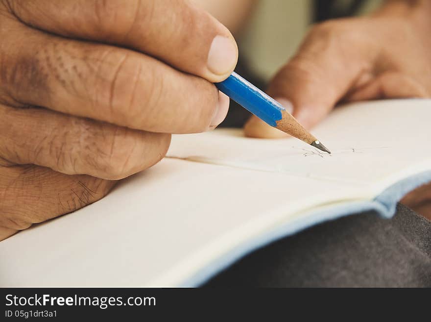 Man writing on sketchbook