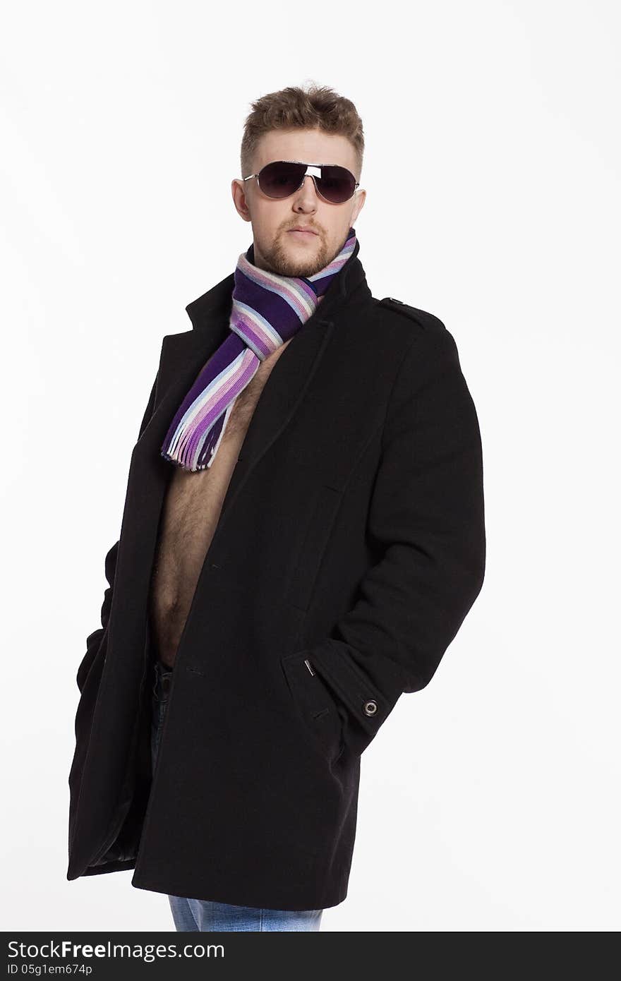 Portrait of handsome stylish blond man in sunglasses and a coat