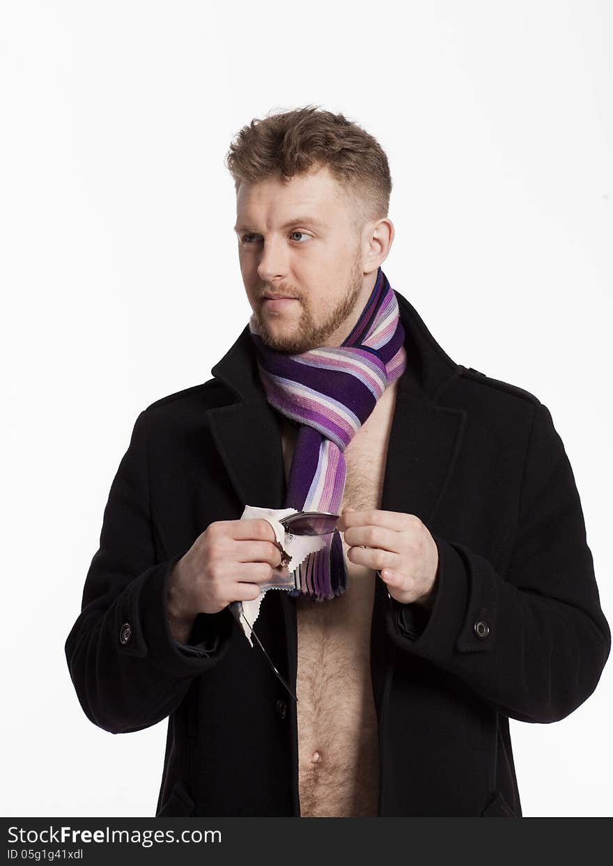 Portrait of handsome stylish blond man in sunglasses and a coat over her naked body in a beautiful stylish scarf