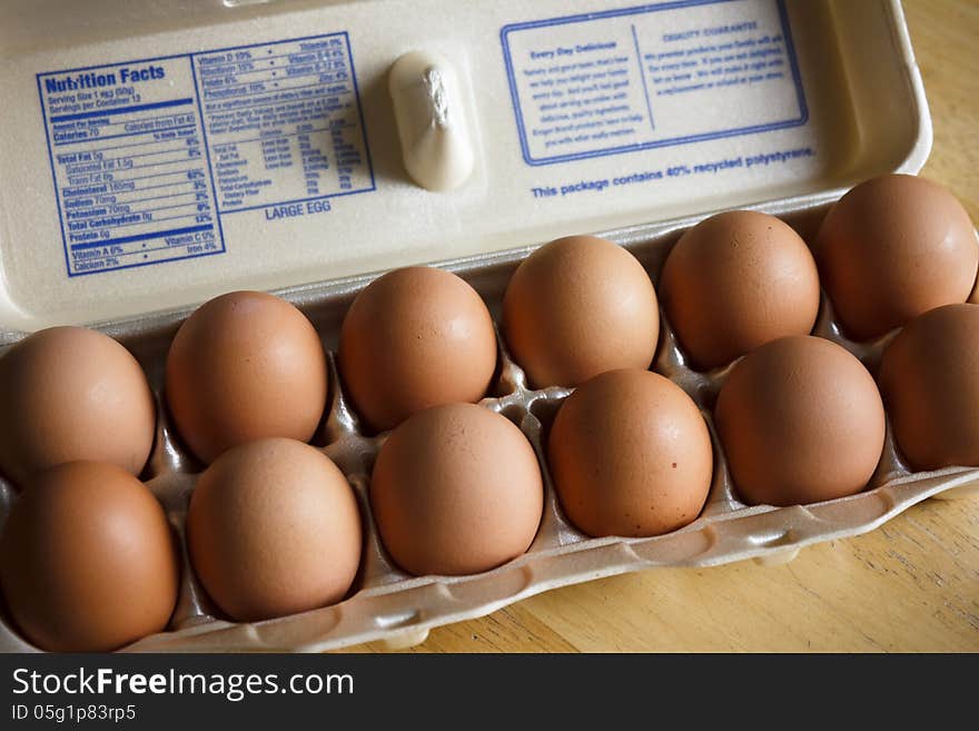 A dozen brown eggs, sometimes called country eggs.