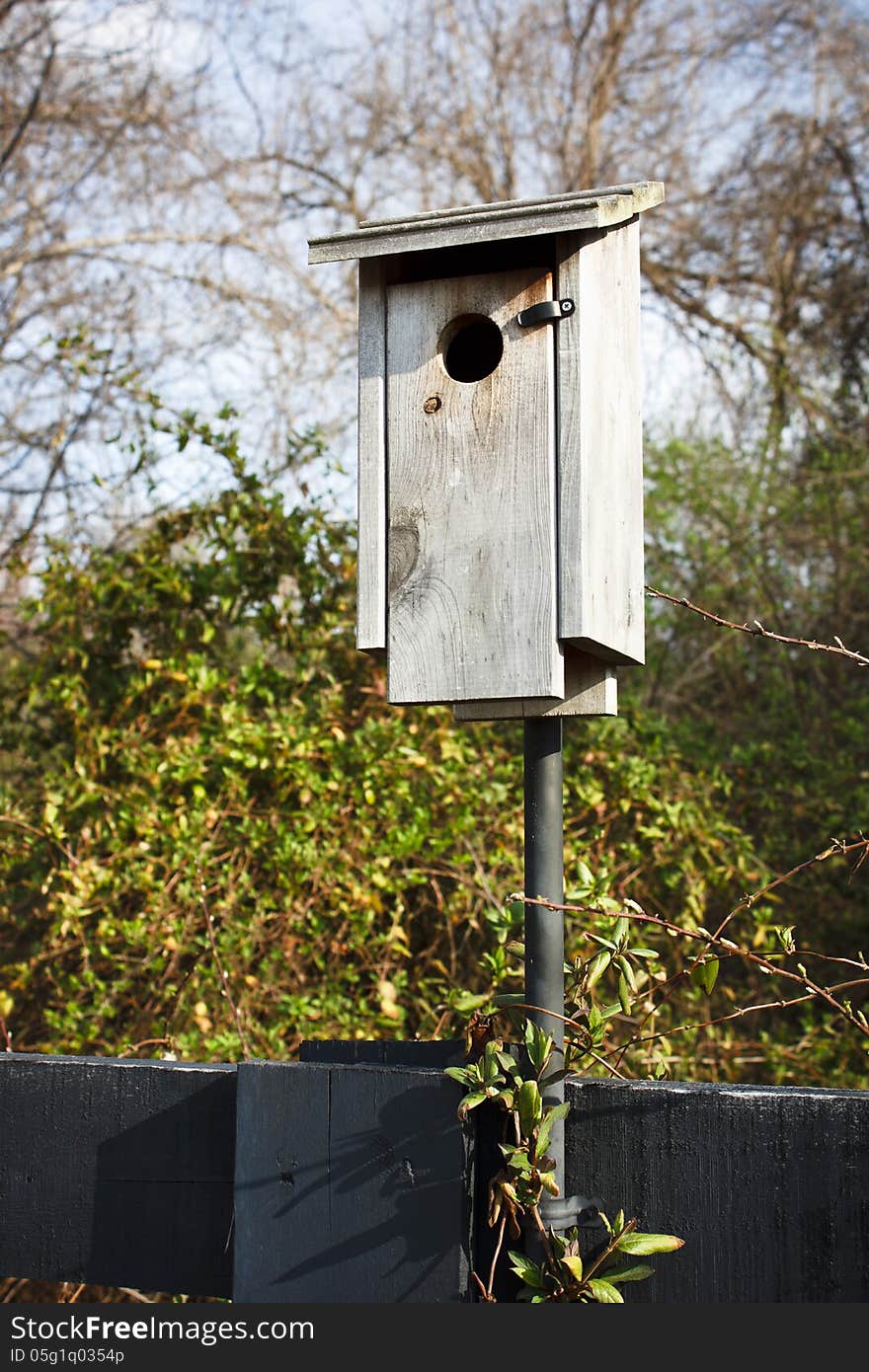 Rustic wooden birdhouse at a local park.