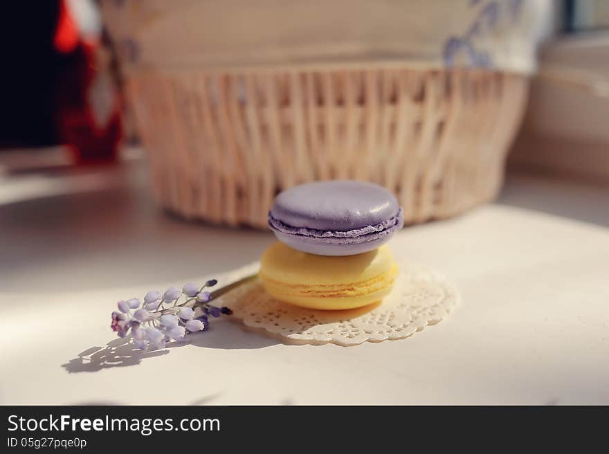 Against the background of a wicker basket on a white napkin round two piece of soap and a flower. Against the background of a wicker basket on a white napkin round two piece of soap and a flower