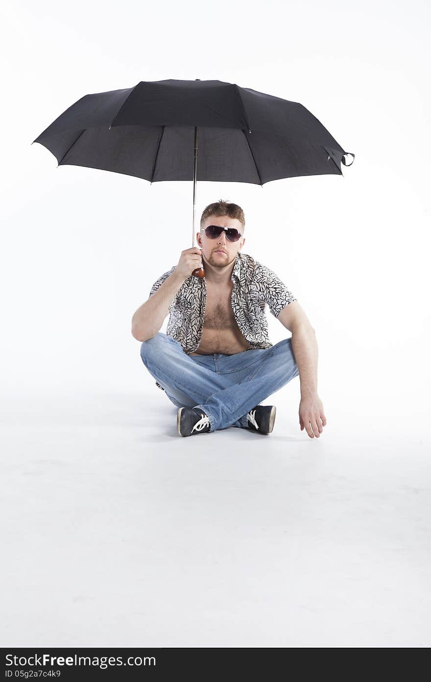 Young businessman under umbrella on vacation. Young businessman under umbrella on vacation