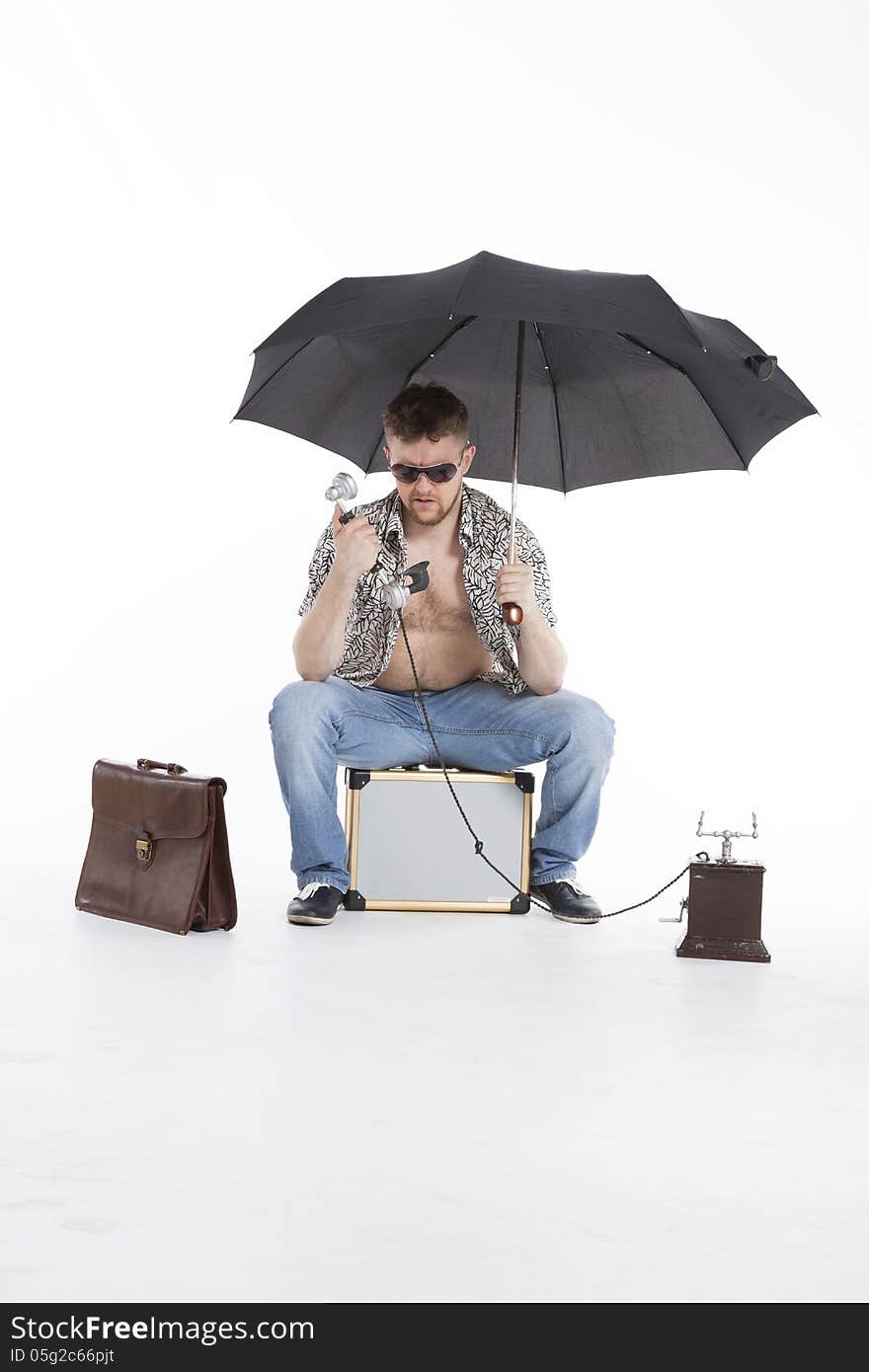 Young businessman under umbrella on vacation. Young businessman under umbrella on vacation