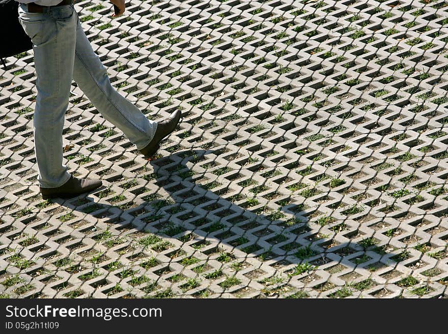 Man walk in The fragment of a pavement footpath