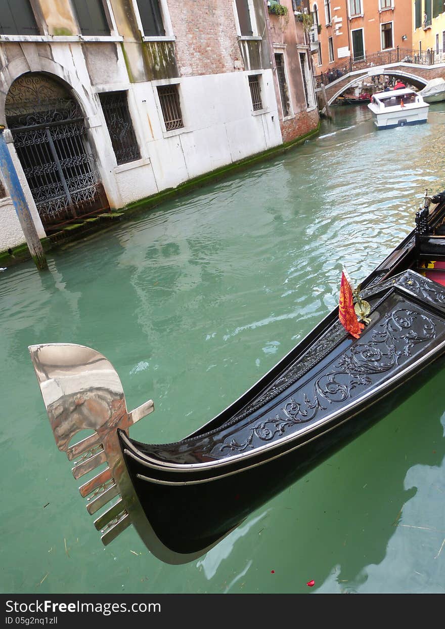 Venice - a detailed view of a gondola on the small town canal. Venice - a detailed view of a gondola on the small town canal