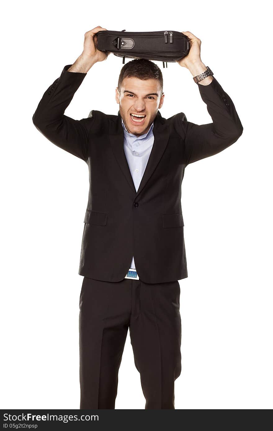 Attractive young businessman screaming with a laptop bag over his head