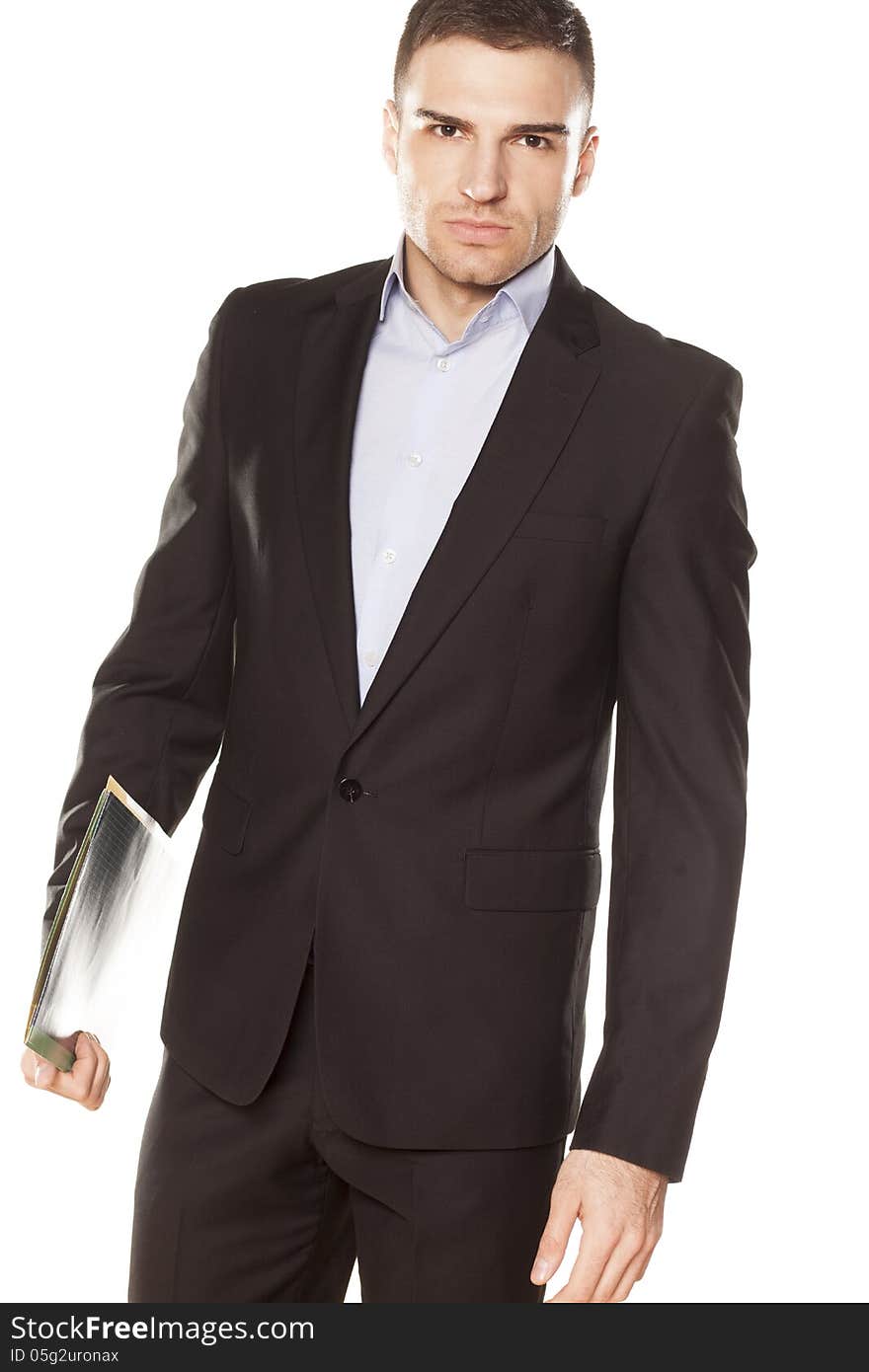 Attractive young businessman with folder in hand posing on a white background