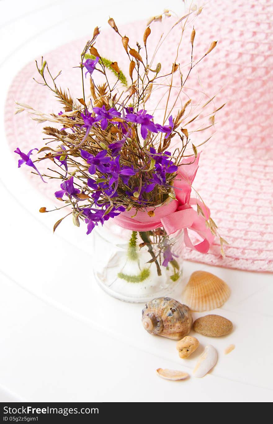 Still life with flowers and a hat