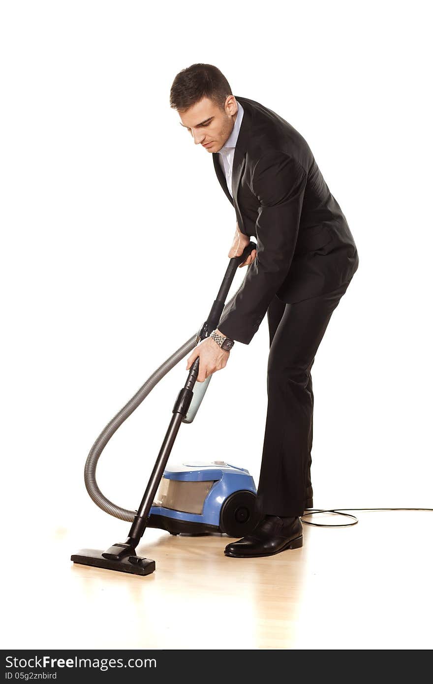 Young attractive businessman with a vacuum cleaner. Young attractive businessman with a vacuum cleaner