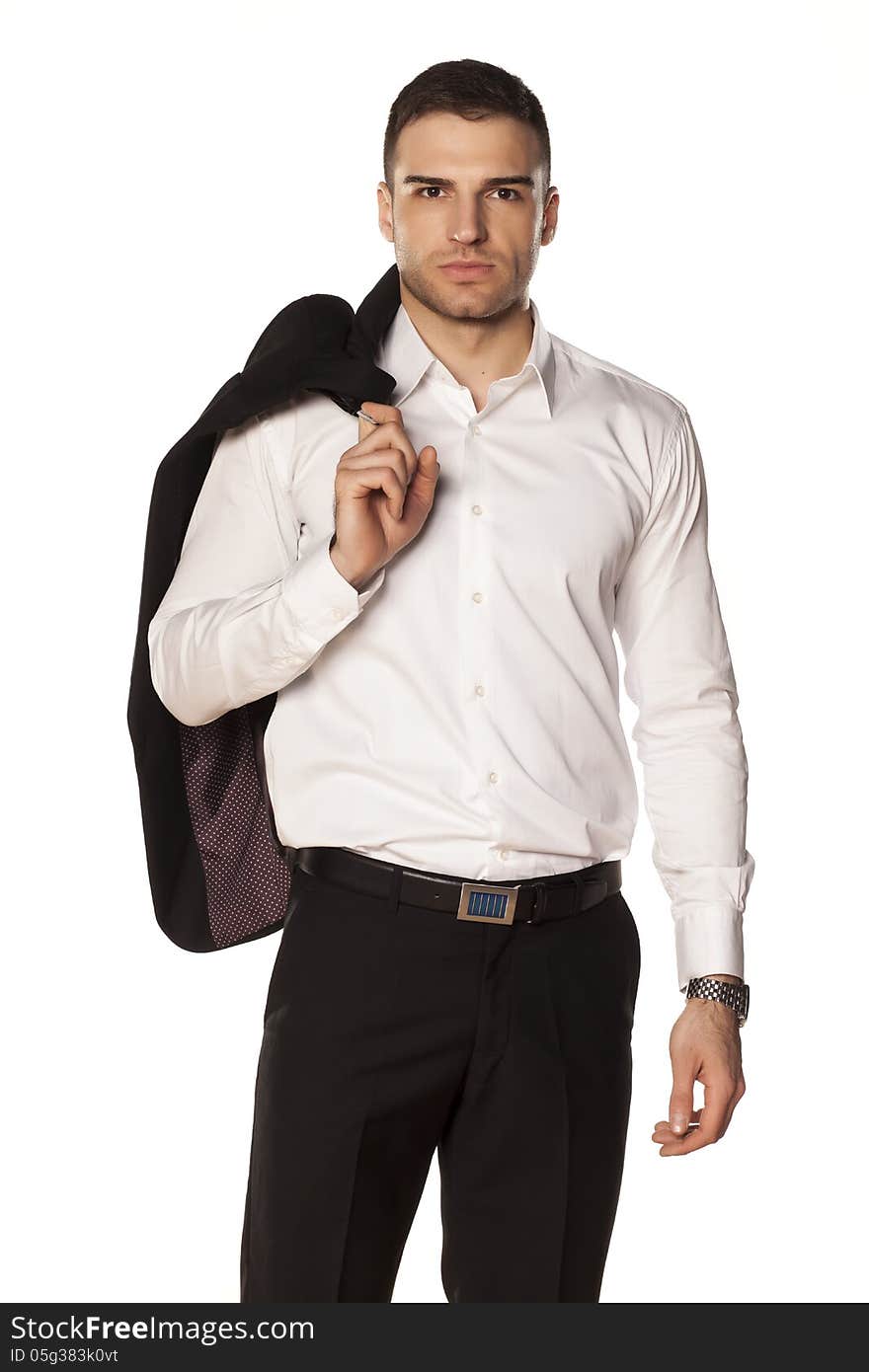 Serious young and attractive businessman in white shirt with a jacket over his shoulder, posing on a white background. Serious young and attractive businessman in white shirt with a jacket over his shoulder, posing on a white background