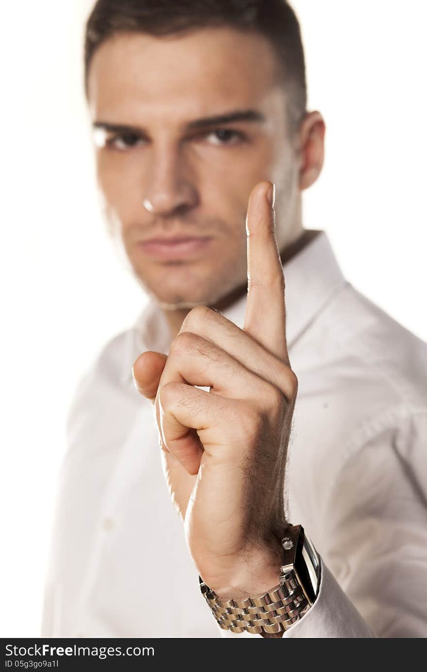 Angry attractive young man points a finger upwards