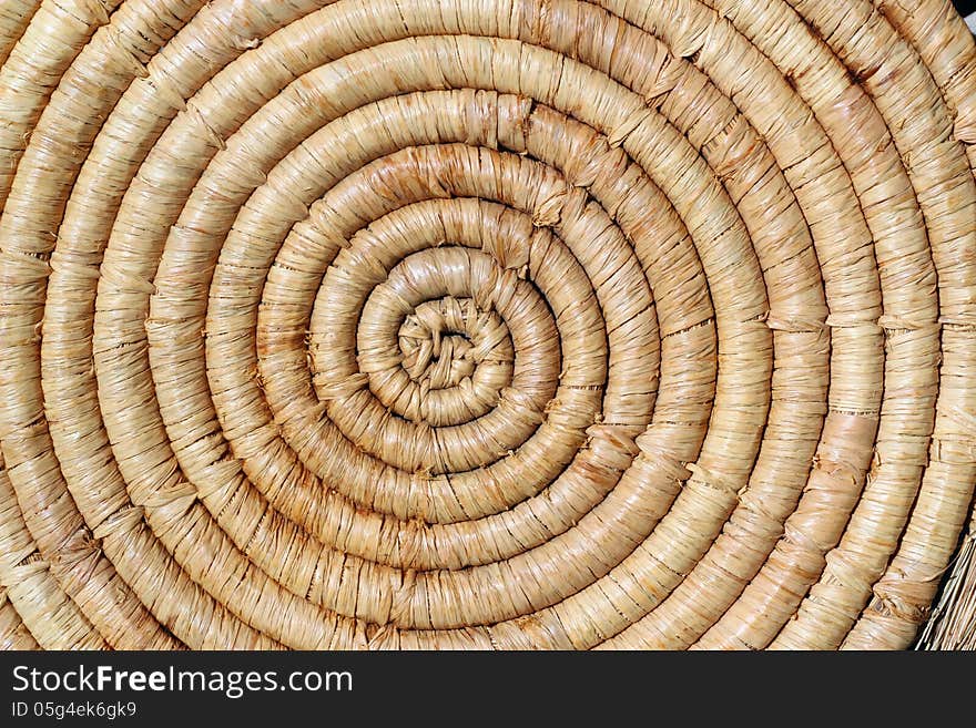 A background of a closeup spiral straw mat. A background of a closeup spiral straw mat