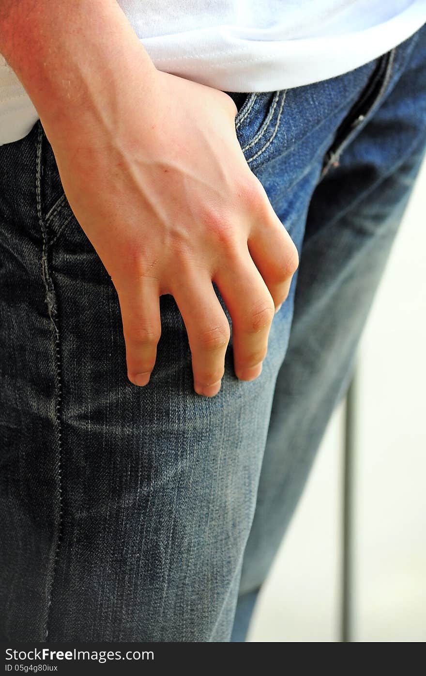 Detail of teenager with hand in his pocket. Detail of teenager with hand in his pocket