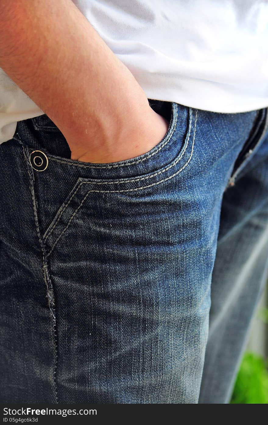 Detail of teenager with hand in trousers pocket. Detail of teenager with hand in trousers pocket