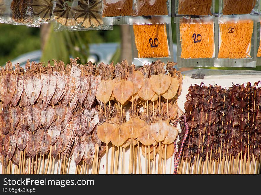 Dried squid skewers a row for sale. Dried squid skewers a row for sale.