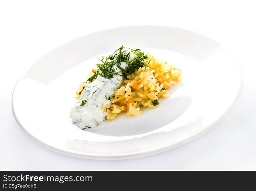 White rice with garlic sauce on a plate on white background