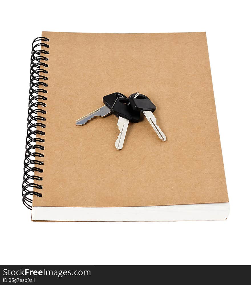 Recycled paper notebook front cover and car keys  isolated