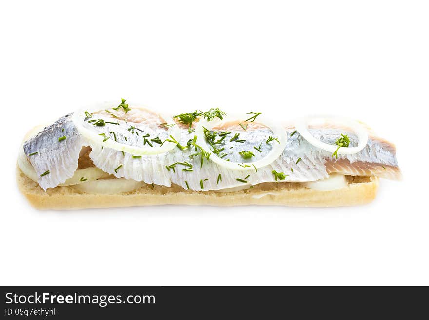 Sandwich with herring, onions and herbs