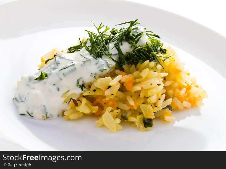 White rice with garlic sauce on a plate on white background