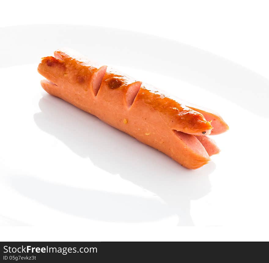 Grilled sausage on a white plate