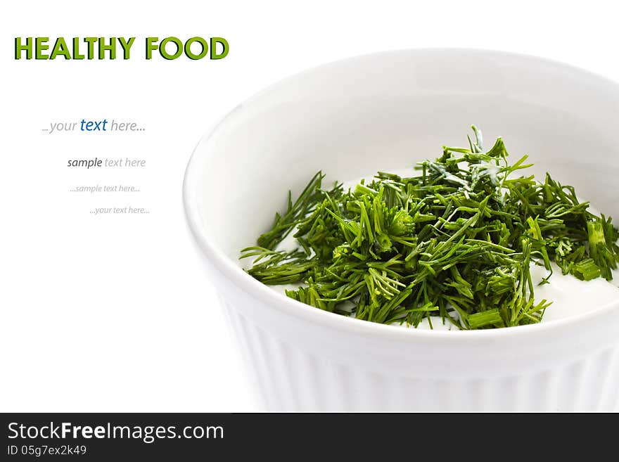 Sour cream in small round plate with herbs, isolated. With sample text