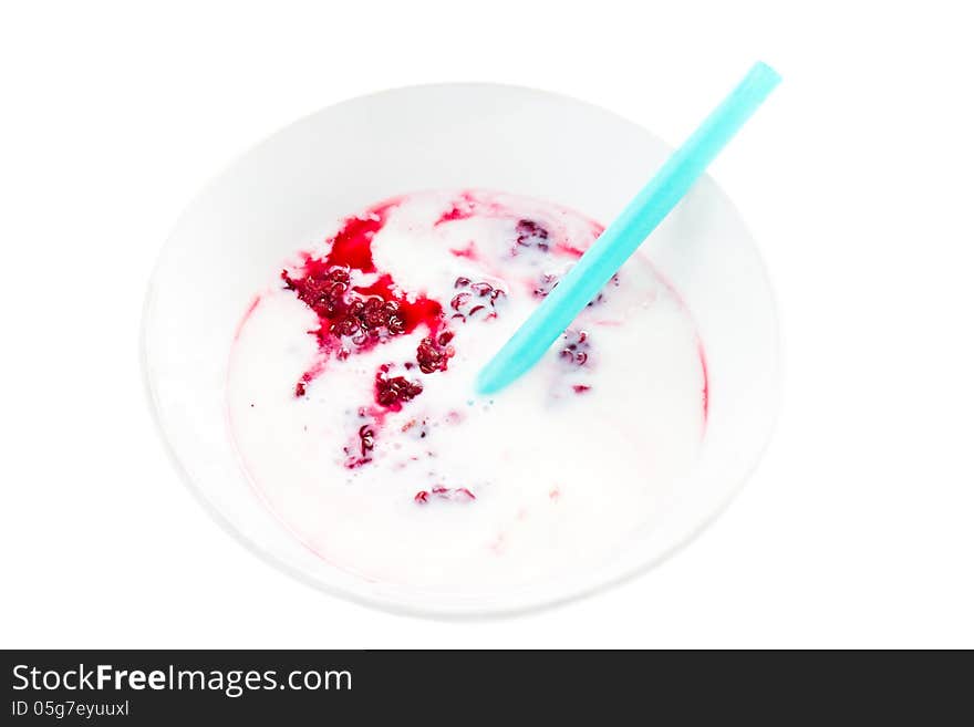 Fresh yogurt with  blackberry in a white bowl with straw, isolated