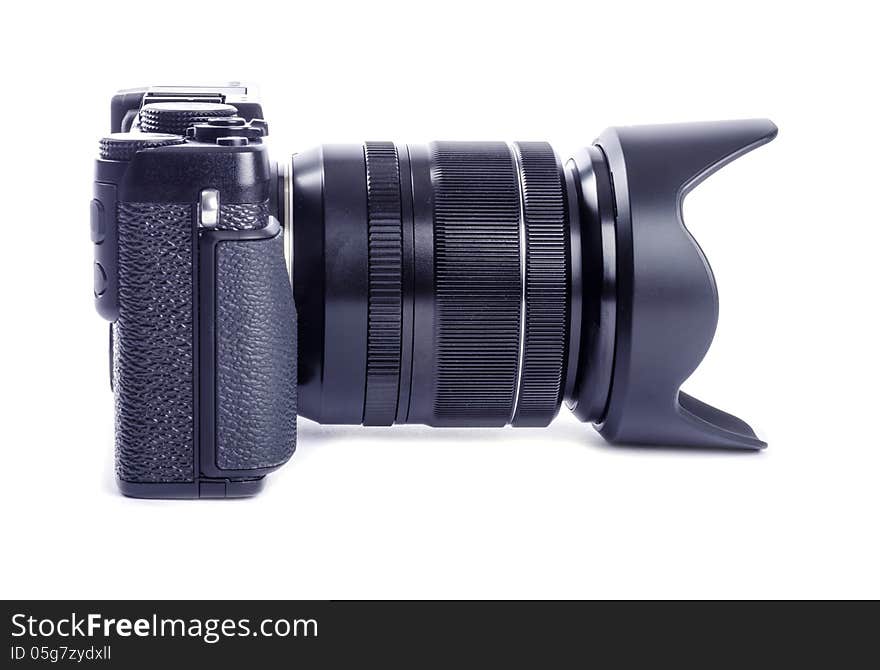 Profile image of a black compact system camera isolated on white.