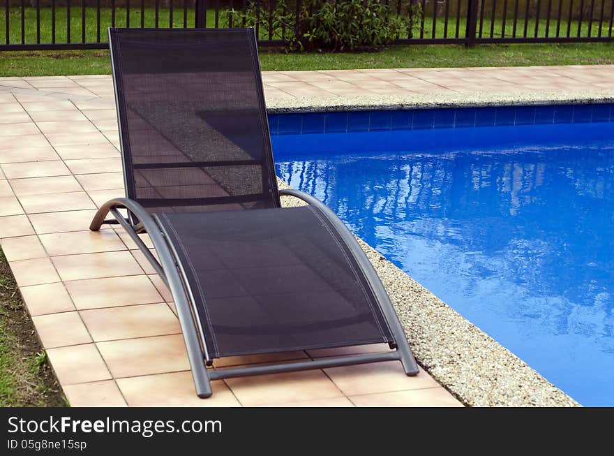 Deck chairs beside a swimming pool