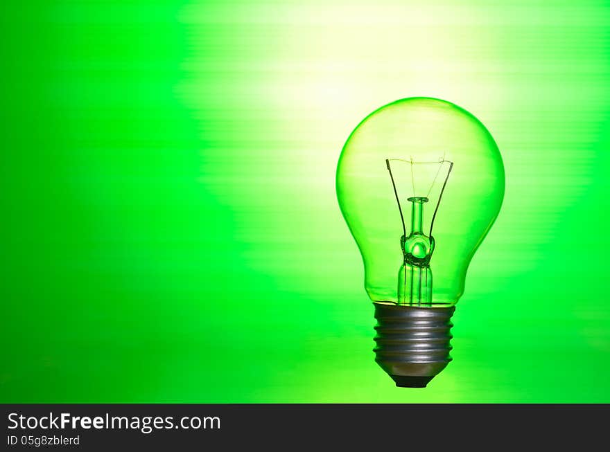 Lamp over green background as eco energy concept