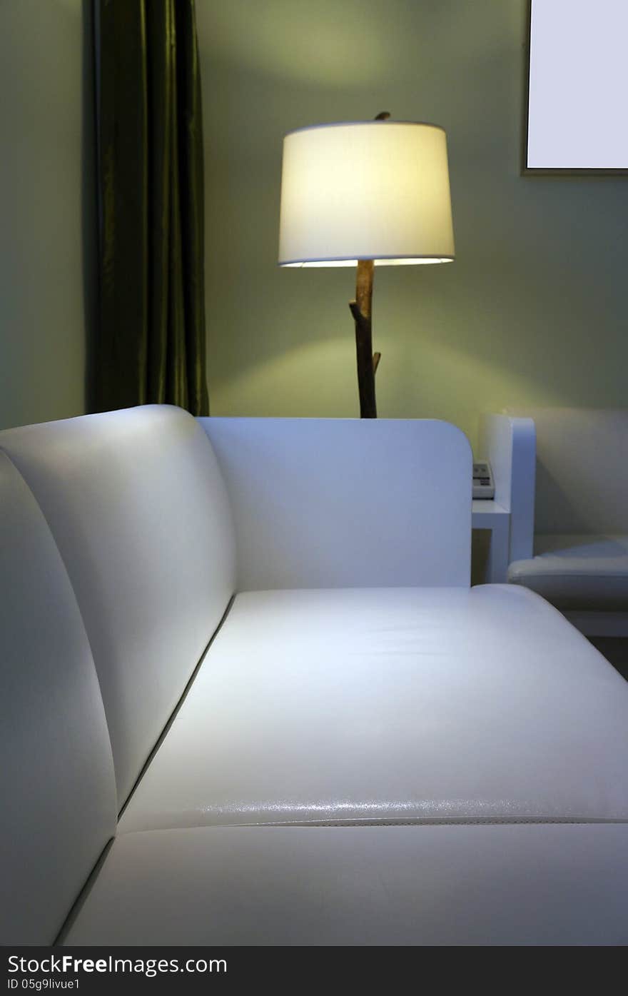 Photo of sofa and standard light. Photo of sofa and standard light.