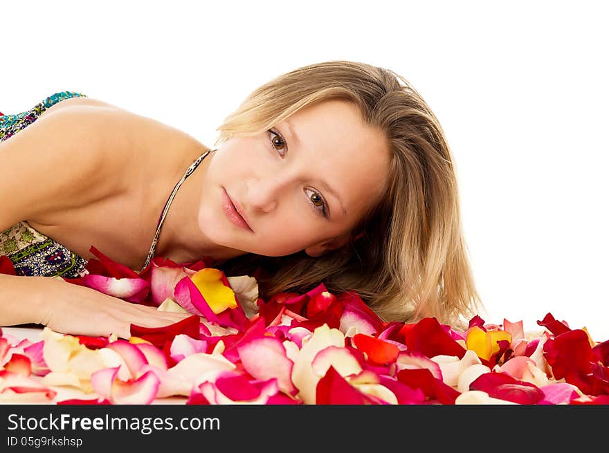 Portrait of a beautiful girl lying in rose petals. Portrait of a beautiful girl lying in rose petals