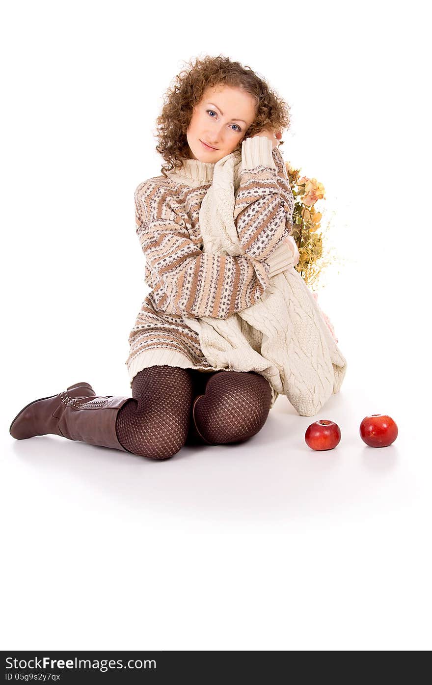 Comfort of a beautiful girl in a sweater sitting with apples